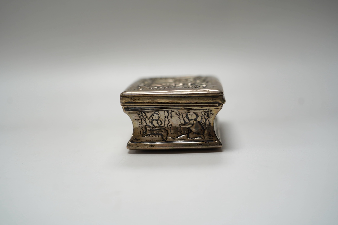 A late 19th century Dutch embossed white metal rectangular snuff box, 83mm, 107 grams. Condition - poor